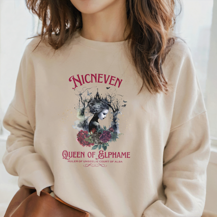 Goth Boho Style Sweatshirt with Nicneven the Queen of Elphame, along with an image of a Dark Fairy Queen and flowers. Winter Warm Cosy oversized sweatshirt, in Sand colour worn by young women.