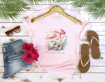 Funny Magical Mushroom T-shirt in soft pink, cute teal and pink fungi graphic, with the text: Fun Girl Looking for a Fungi - ideal gift for foragers.